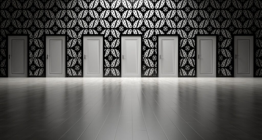 A hallway with six closed white doors against a black and white patterned wall, reflecting on a shiny floor, evokes the feeling of “fear of choice” when you find yourself at the crossroads of decision.